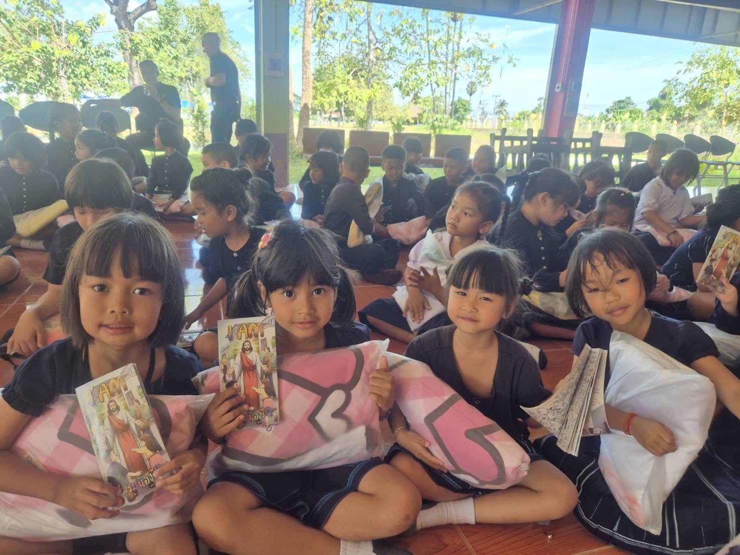 Children with donated bed linen at a school in Thailand